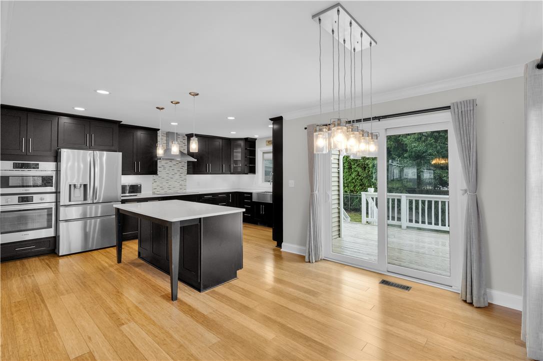 3396 Darien Road Bethlehem, PA 18020 - Photo 12 of 44 A contemporary kitchen and dining space seamlessly connect to outdoor living through a glass sliding door.