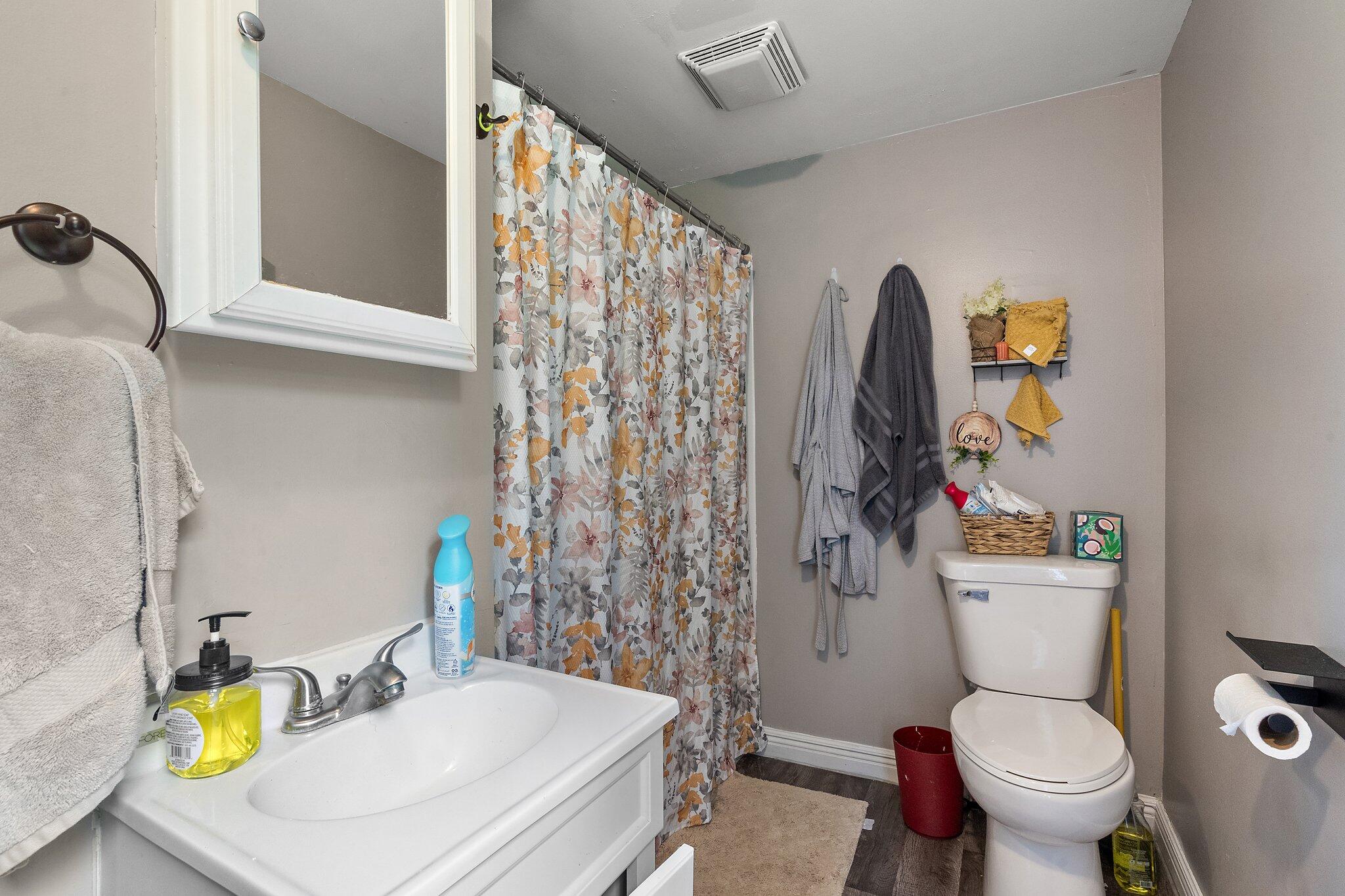 1532 2nd Street La Porte, IN 46350 - Photo 11 of 31 a bathroom with a sink a toilet and a shower curtain