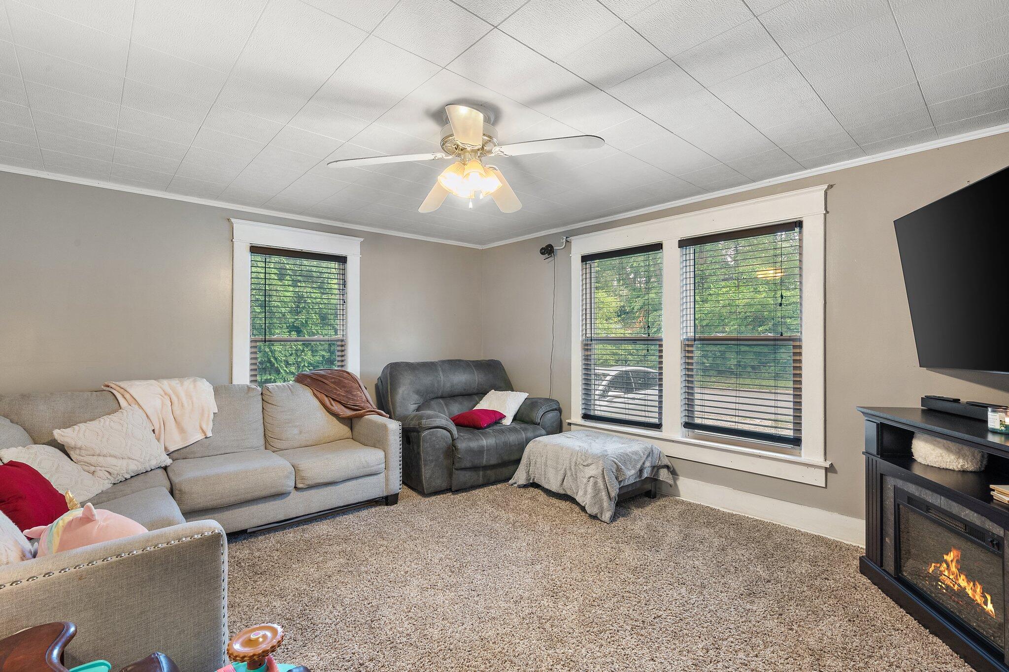 1532 2nd Street La Porte, IN 46350 - Photo 6 of 31 a living room with furniture a flat screen tv and a large window