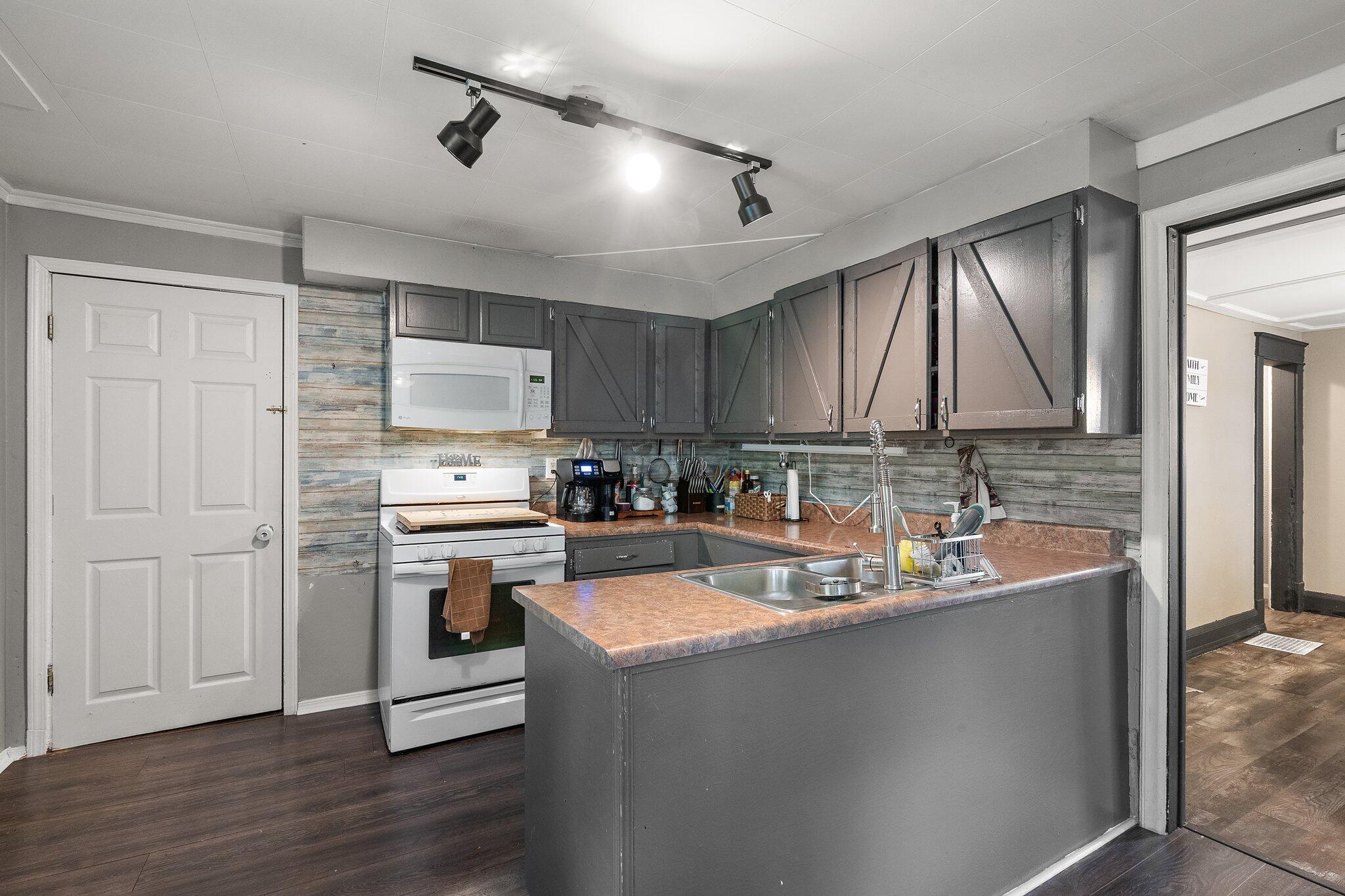 1532 2nd Street La Porte, IN 46350 - Photo 7 of 31 a kitchen with a sink stove and refrigerator