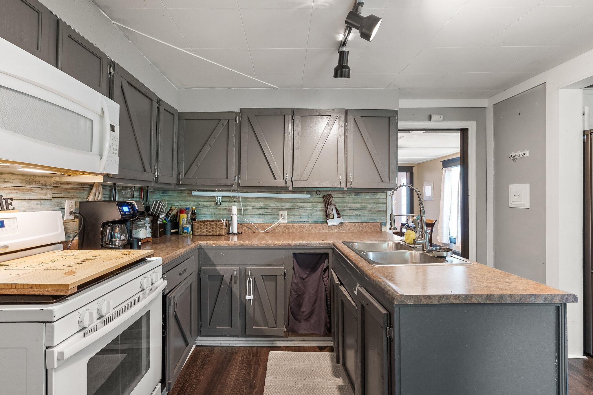 1532 2nd Street La Porte, IN 46350 - Photo 8 of 31 a kitchen with a sink a stove and cabinets