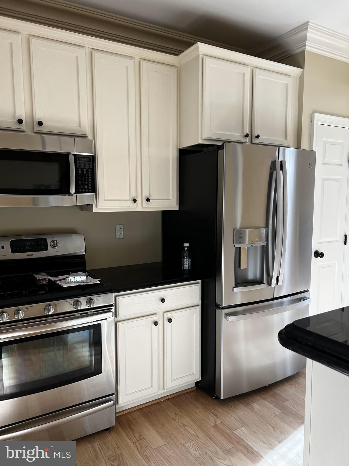 1731 Derrs Square West Frederick, MD 21701 - Photo 3 of 23 a kitchen with granite countertop white cabinets and stainless steel appliances
