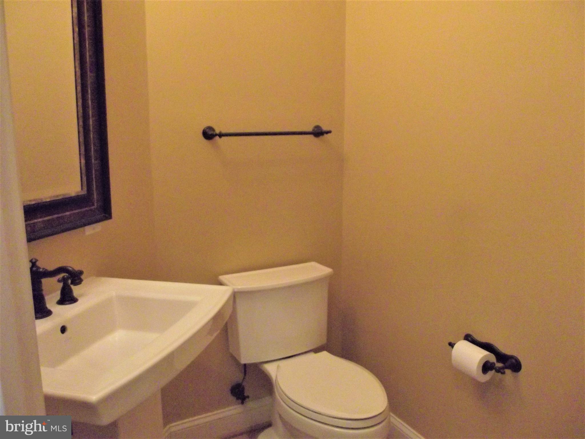 1731 Derrs Square West Frederick, MD 21701 - Photo 4 of 23 a white toilet sitting next to a white sink