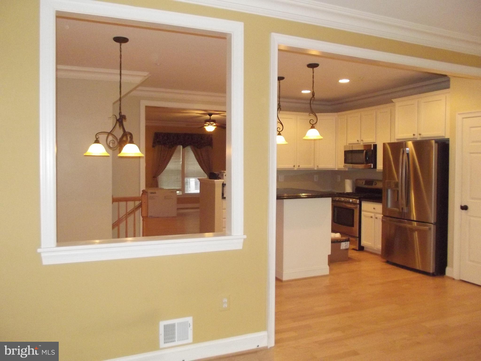 1731 Derrs Square West Frederick, MD 21701 - Photo 7 of 23 a kitchen with stainless steel appliances granite countertop a refrigerator and a stove top oven