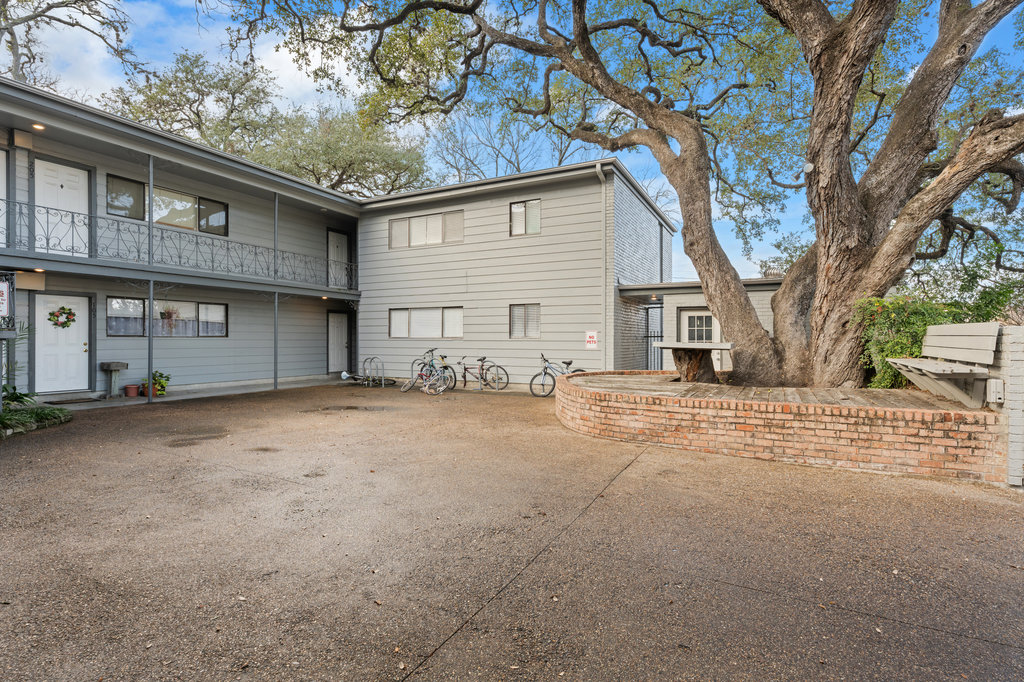 803 West 28th Street, Unit 206 Austin, TX 78705 - Photo 19 of 25 a view of a house with a large tree and wooden fence