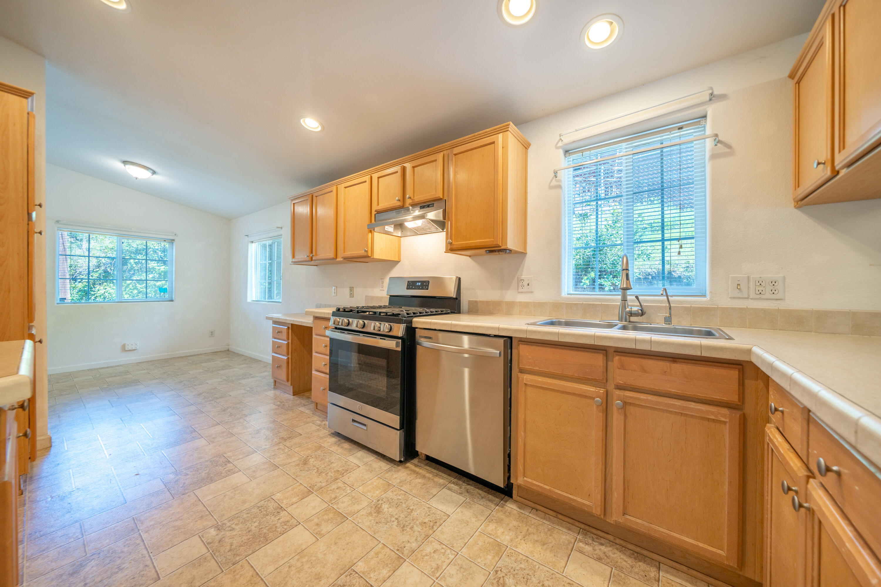 22151 Ravine Court Redding, CA 96003 - Photo 7 of 34 a kitchen with stainless steel appliances granite countertop a stove a sink and a microwave