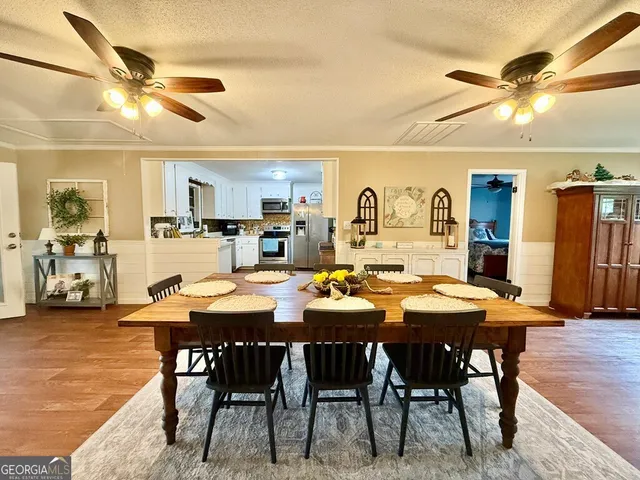a view of a a dining room with furniture window and wooden floor