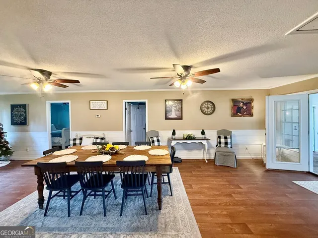 a view of a dining room with furniture and chandelier
