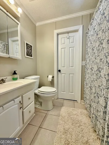 a spacious bathroom with a toilet sink and a shower