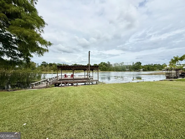 a view of a lake with houses in the back