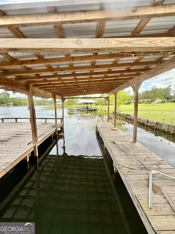 a view of a lake with houses in the back