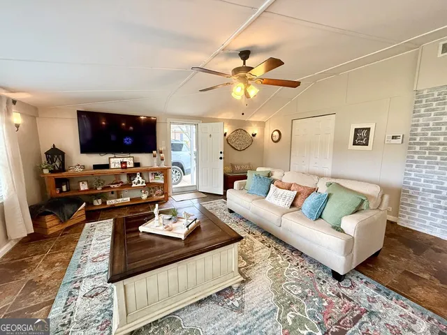 a living room with furniture and a flat screen tv