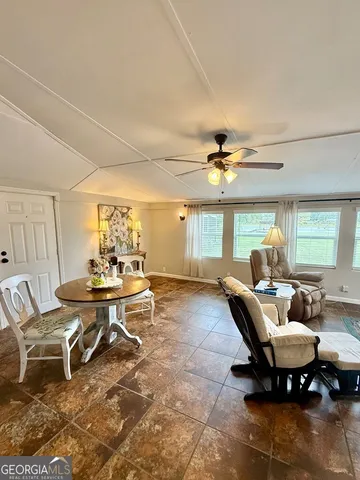 a living room with furniture a chandelier and a table