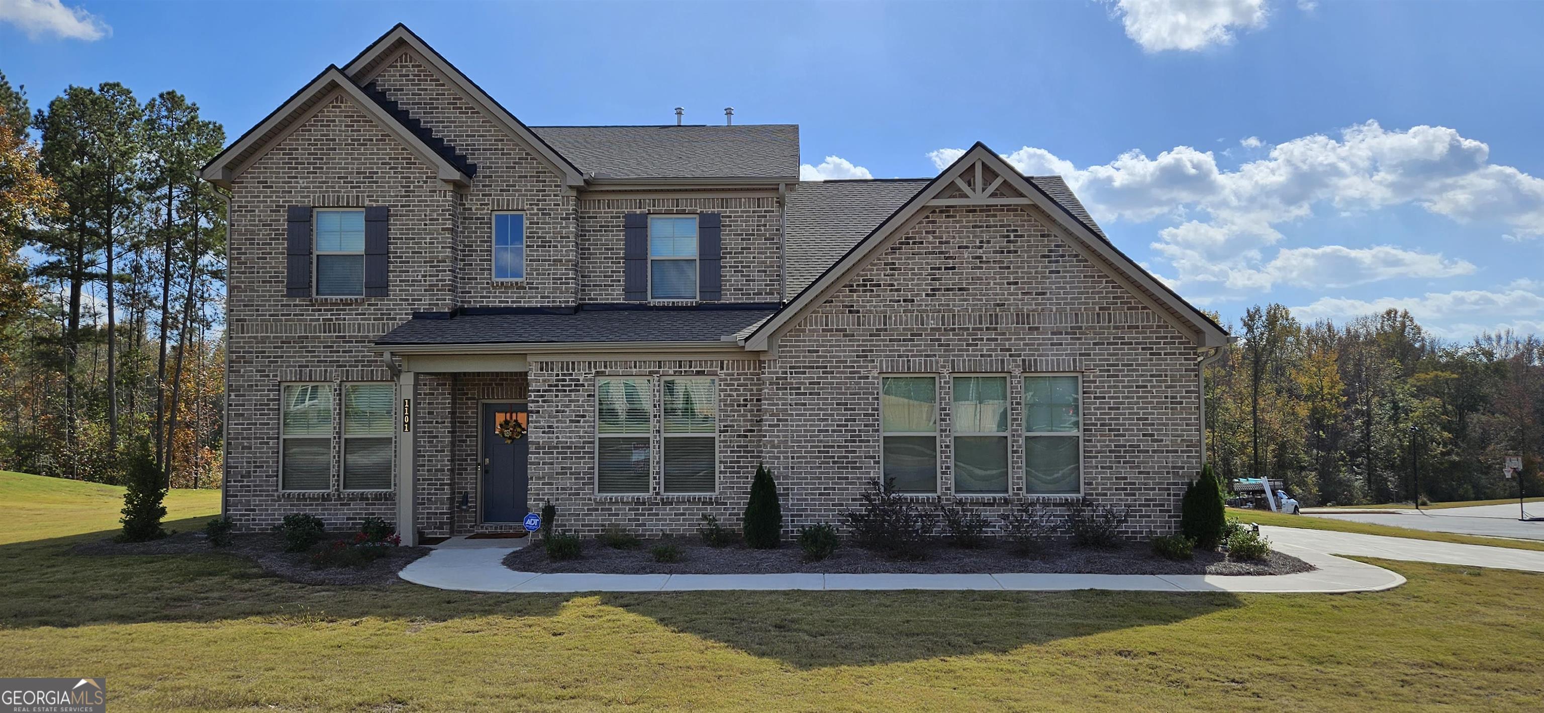a front view of a house with a yard