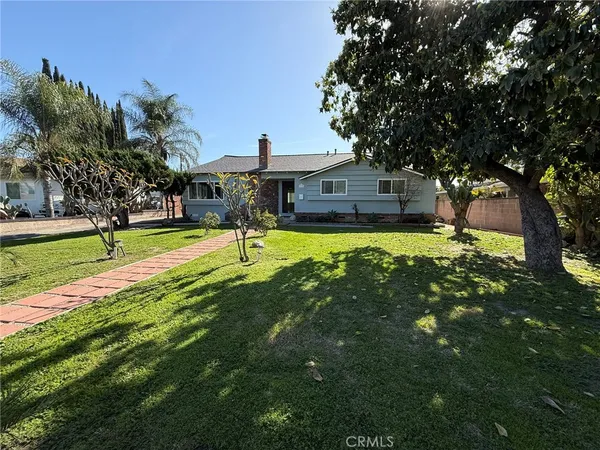 a front view of a house with a yard bathtub and trees