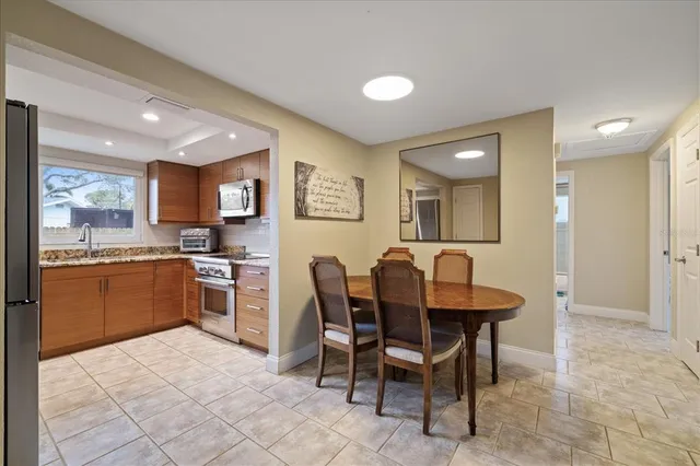 a kitchen with granite countertop a sink counter space and stainless steel appliances