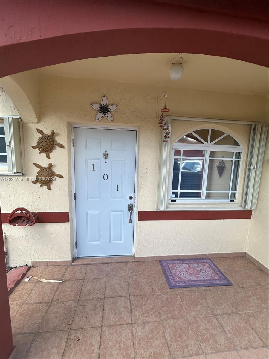 10919 West Okeechobee Road, Unit 101 Hialeah Gardens, FL 33018 - Photo 3 of 21 a view of front door of house