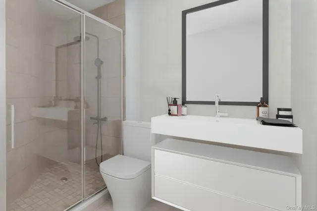a bathroom with a sink toilet and shower