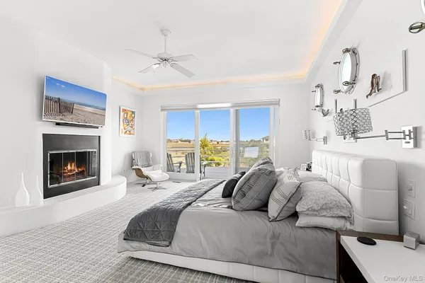 a large bedroom with a bed and a fireplace