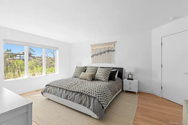 a bedroom with a bed and a large window