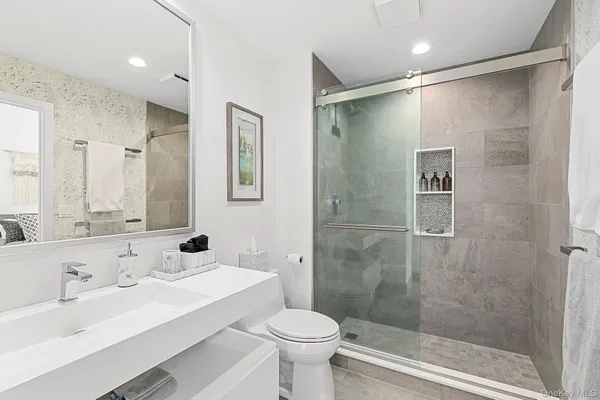 a bathroom with a sink toilet and shower