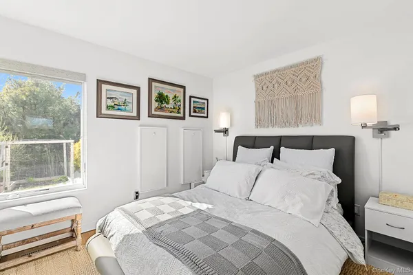 a bedroom with bed and a window