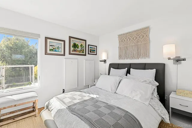 a bedroom with bed and a window