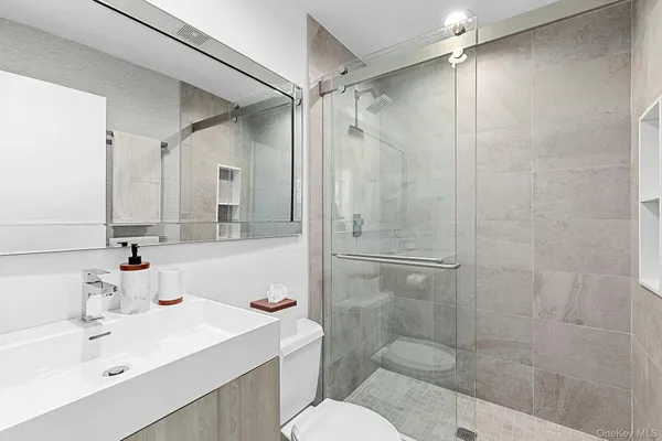 a bathroom with a sink toilet and shower