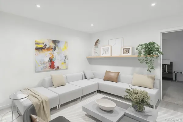 a living room with furniture and a potted plant