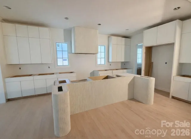 a living room with stainless steel appliances kitchen island granite countertop furniture and a refrigerator