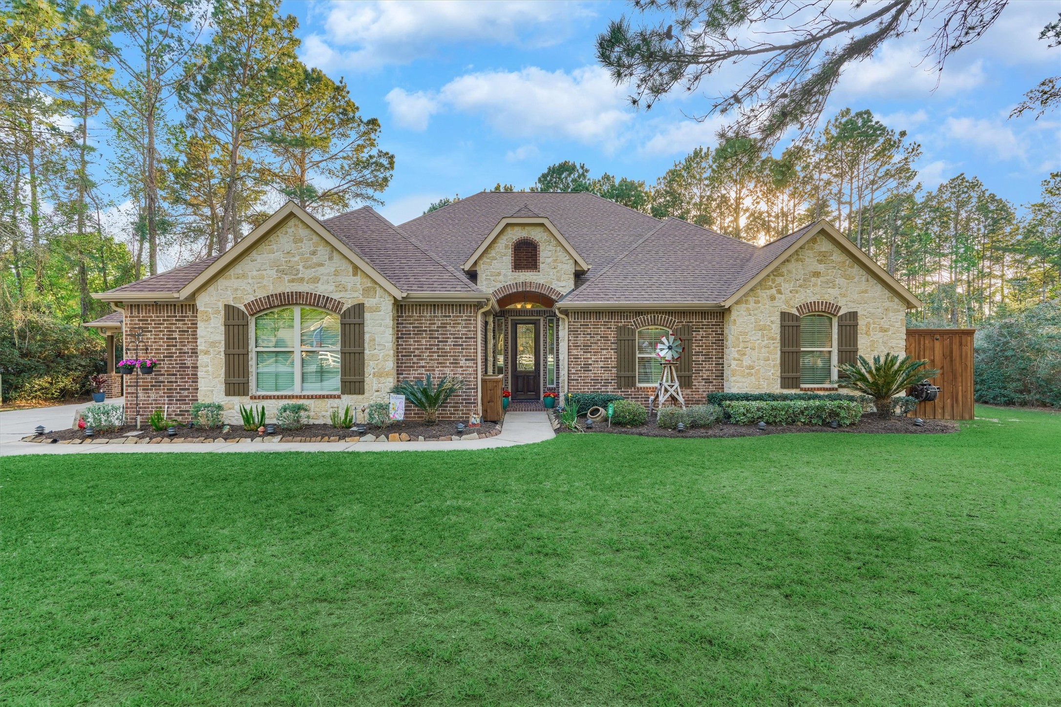Stunning curb appeal with beautifully maintained landscaping and inviting front elevation.