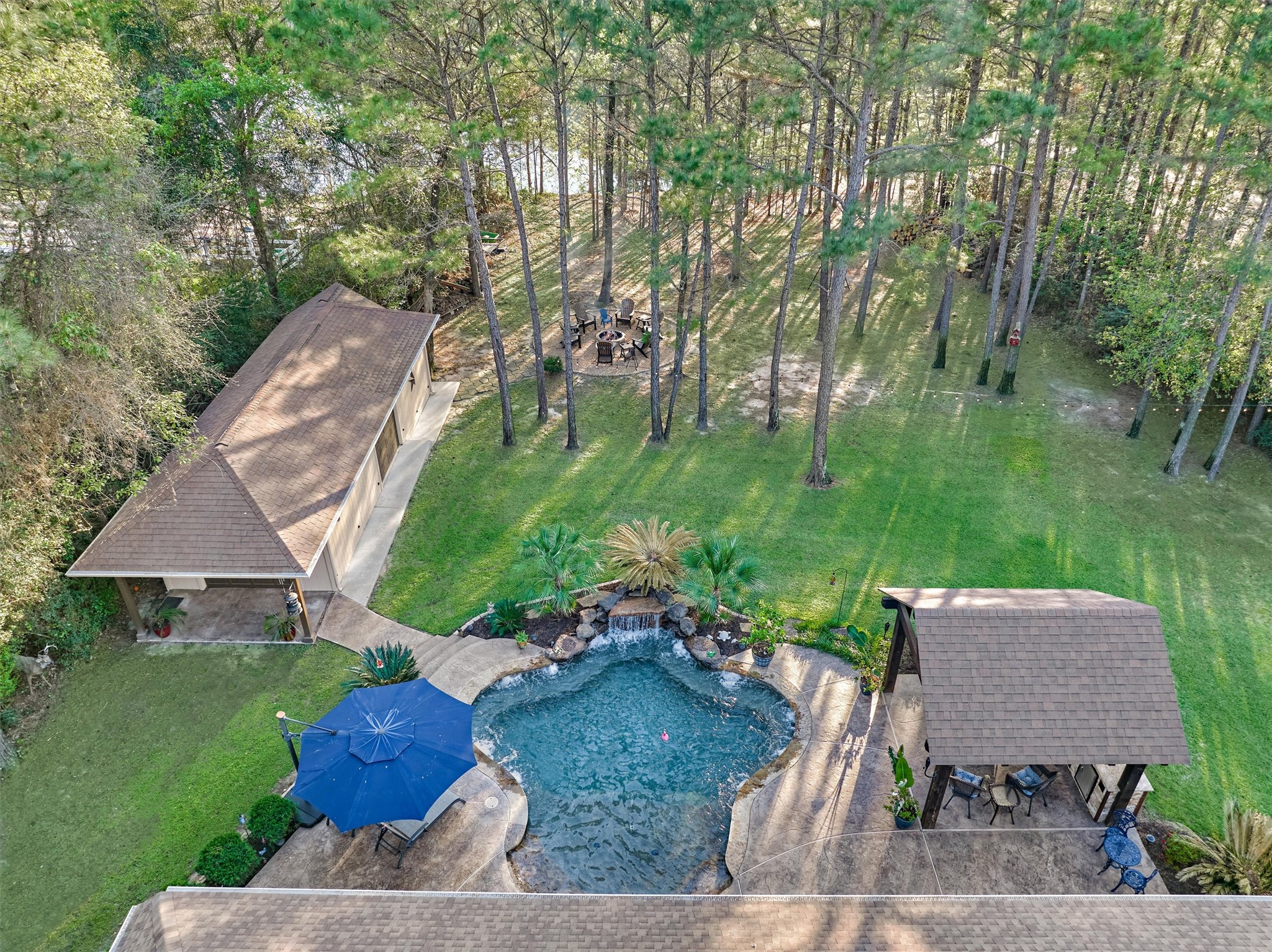 11598 Sebastian's Run Montgomery, TX 77316 - Photo 3 of 50 Resort-Style backyard featuring a workshop, sparkling pool, and outdoor kitchen. Perfect for entertaining.
