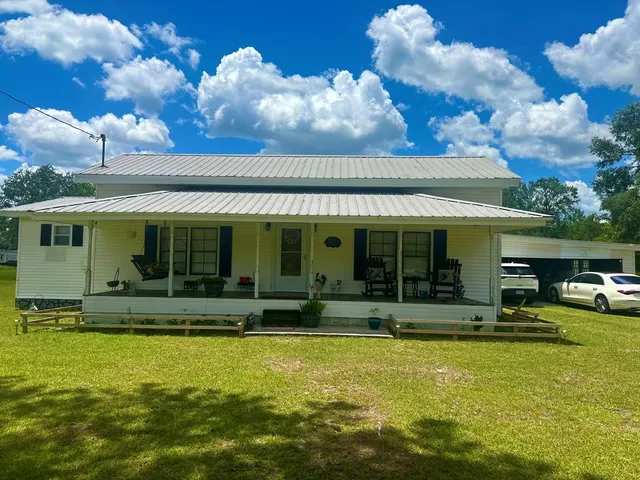 a view of a house with swimming pool and porch