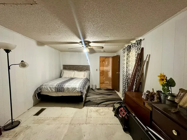 a bedroom with a bed and a mirror