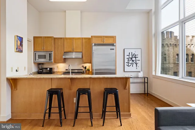 a kitchen with stainless steel appliances kitchen island granite countertop a sink and cabinets