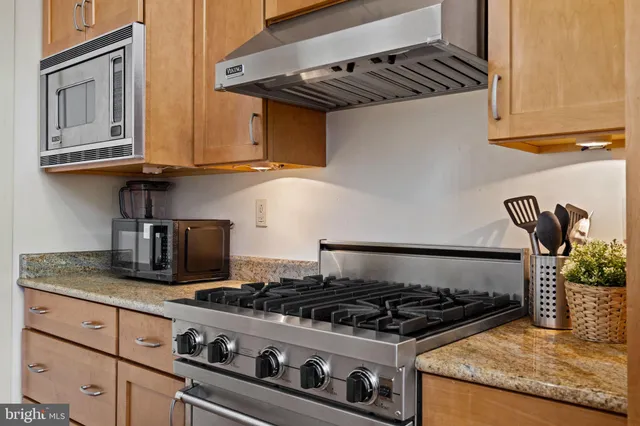 a kitchen that has a sink and a stove