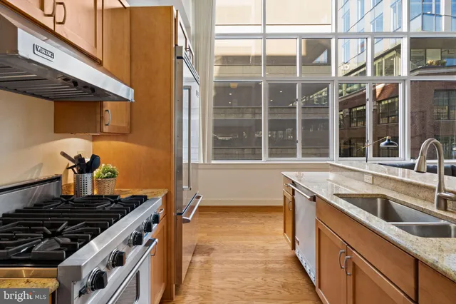 a kitchen with stainless steel appliances granite countertop a refrigerator and a sink