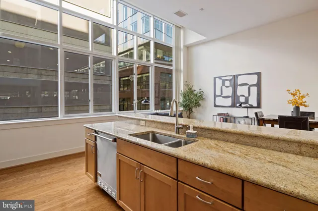a view of a livingroom with wooden floor and stairs