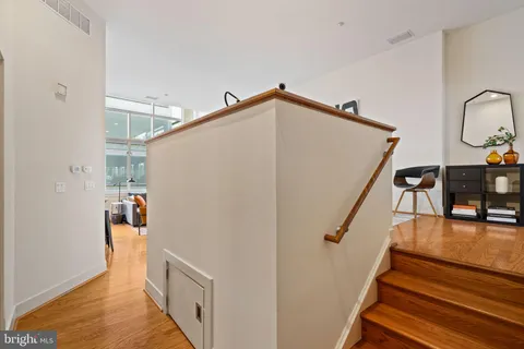 a room with painting on the wall and a table