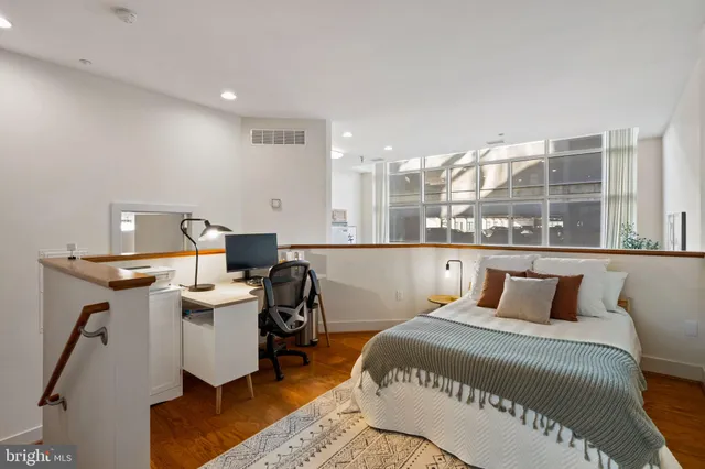 a view of a workspace with furniture and a window