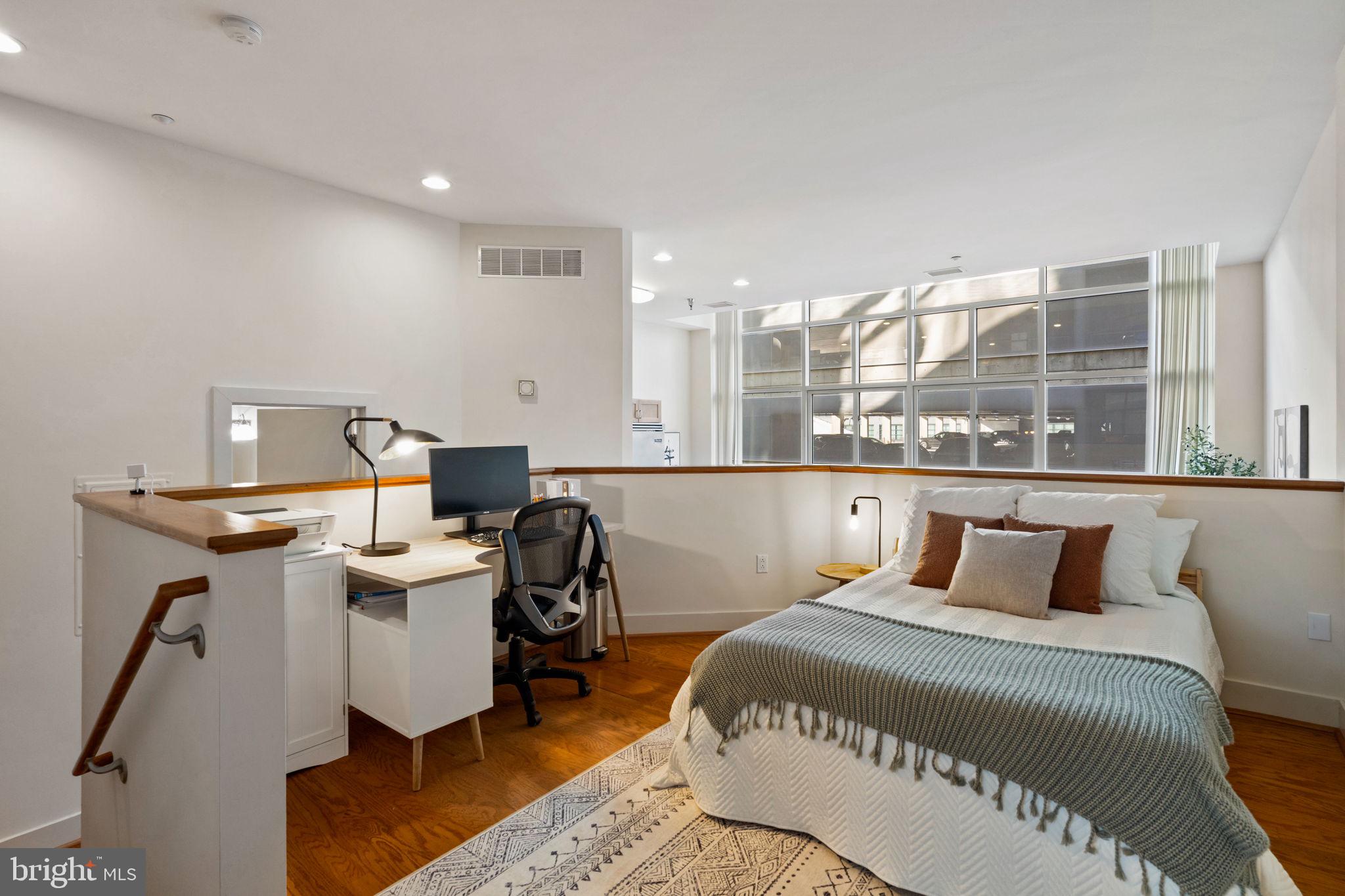 23 South 23rd Street, Unit 3D Philadelphia, PA 19103 - Photo 25 of 37 a bedroom with a bed and wooden floor