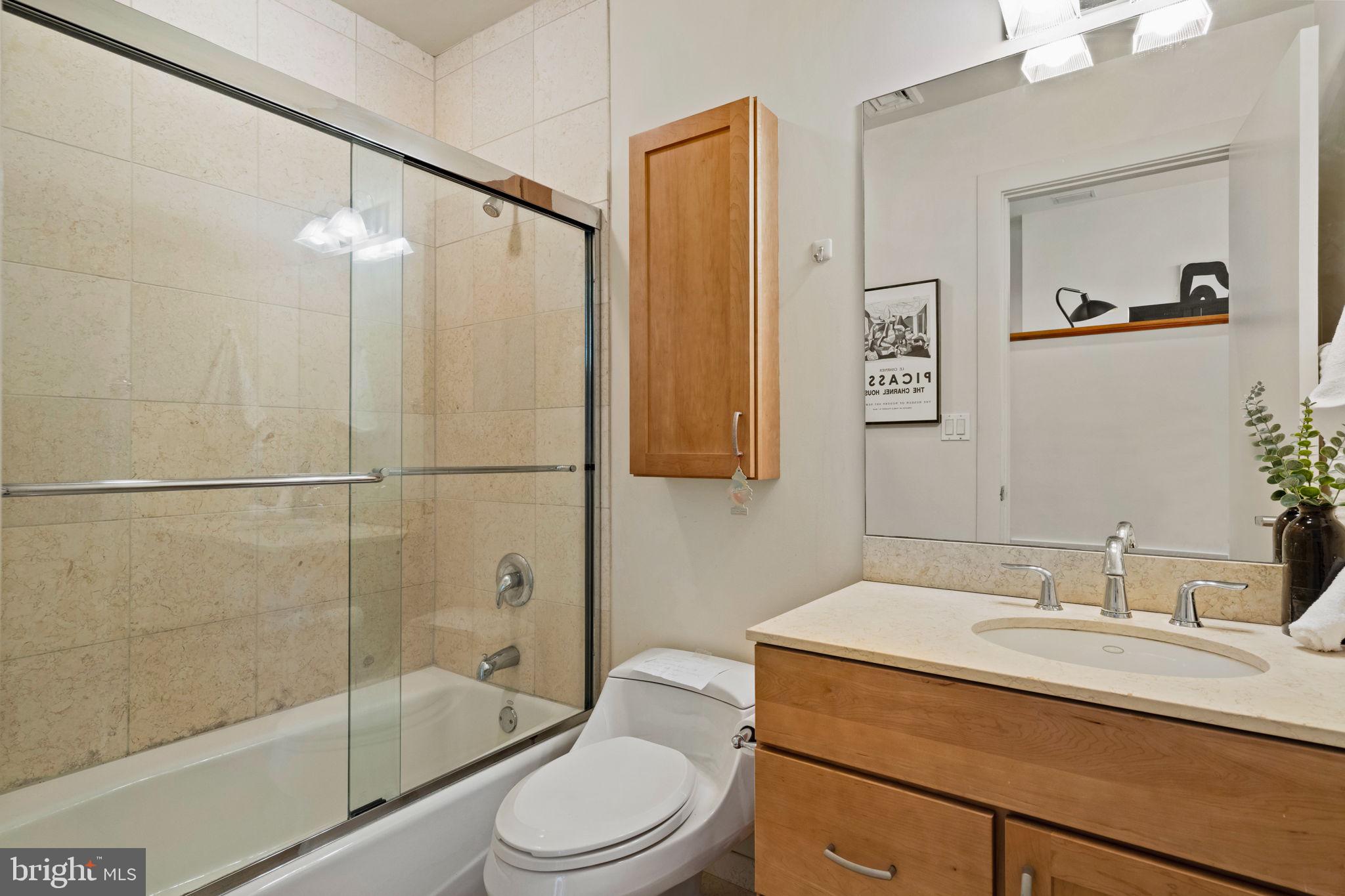 23 South 23rd Street, Unit 3D Philadelphia, PA 19103 - Photo 29 of 37 a bathroom with a sink a toilet and shower