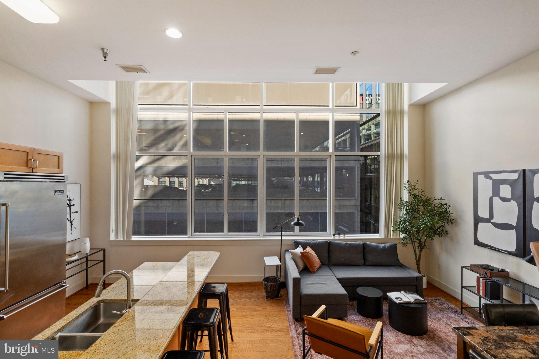 23 South 23rd Street, Unit 3D Philadelphia, PA 19103 - Photo 4 of 37 a living room with furniture and windows