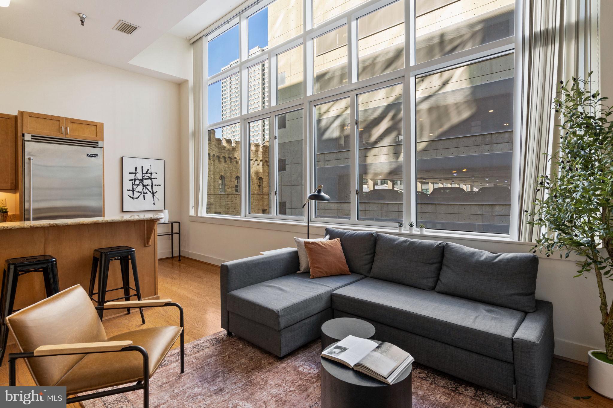 23 South 23rd Street, Unit 3D Philadelphia, PA 19103 - Photo 8 of 37 a living room with furniture and a large window