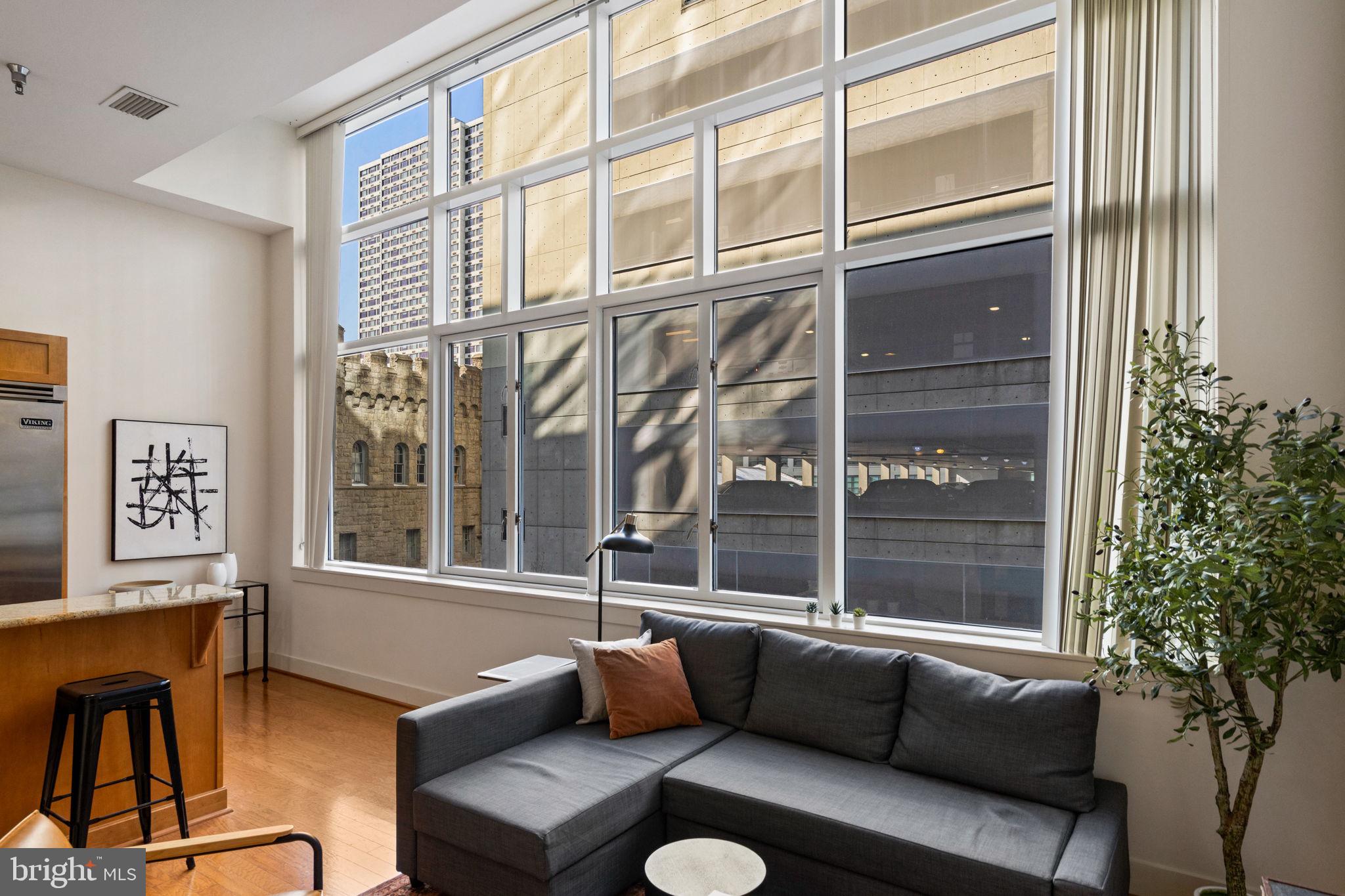 23 South 23rd Street, Unit 3D Philadelphia, PA 19103 - Photo 10 of 37 a living room with furniture and a window