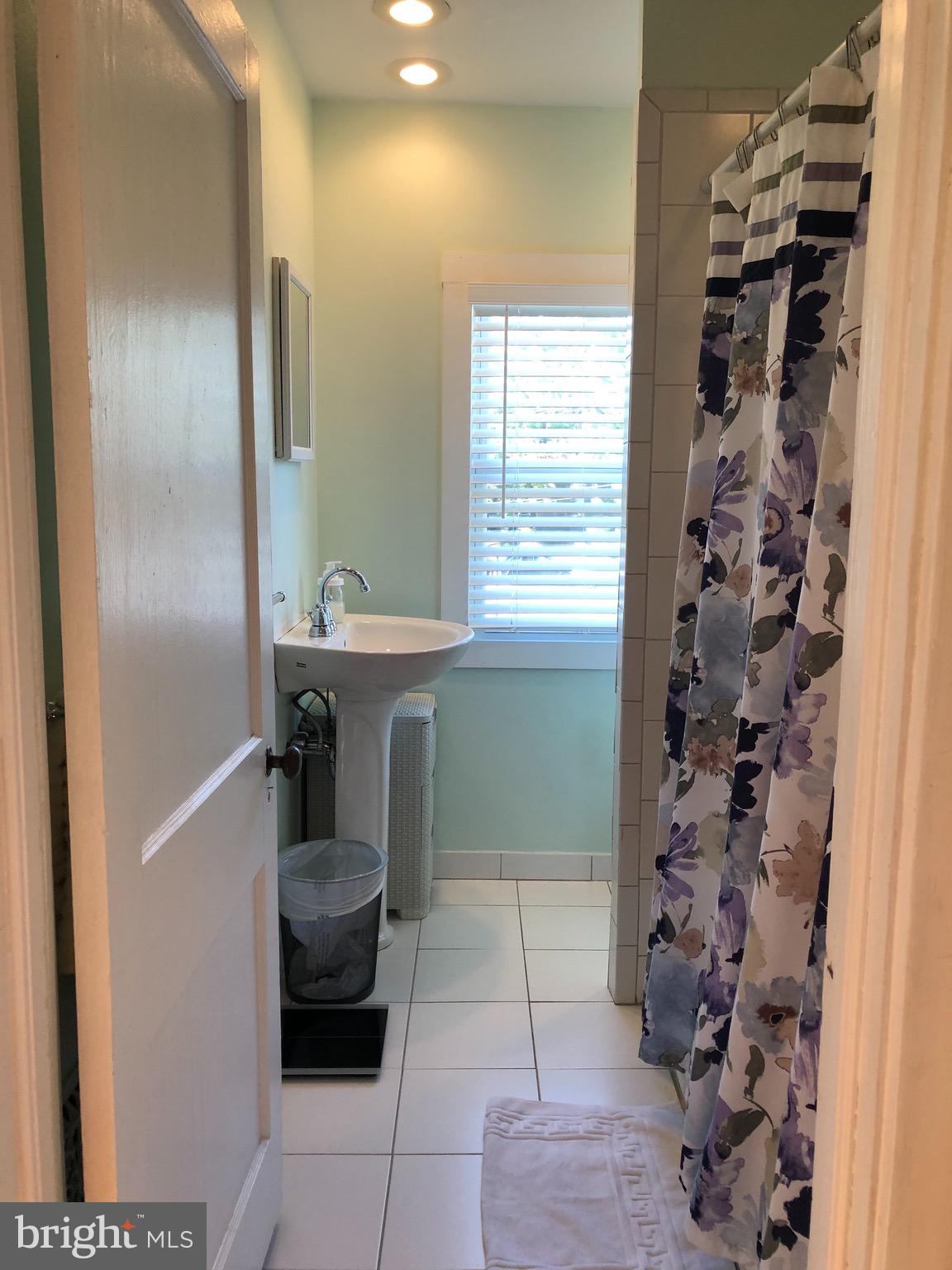 224 Rockingham Road Bryn Mawr, PA 19010 - Photo 14 of 23 a bathroom with a sink and a shower