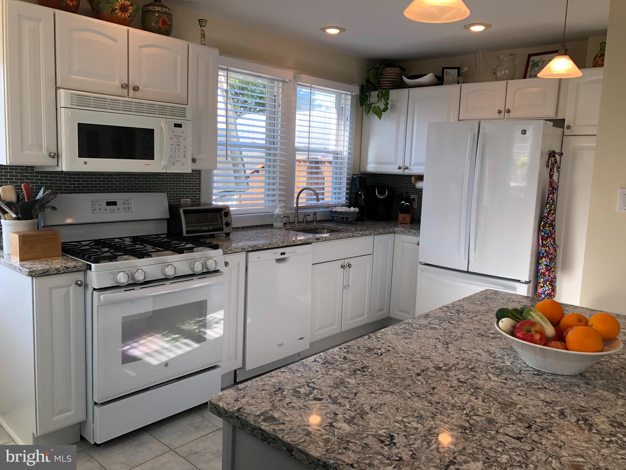 224 Rockingham Road Bryn Mawr, PA 19010 - Photo 8 of 23 a kitchen with stainless steel appliances granite countertop a stove a sink and a refrigerator