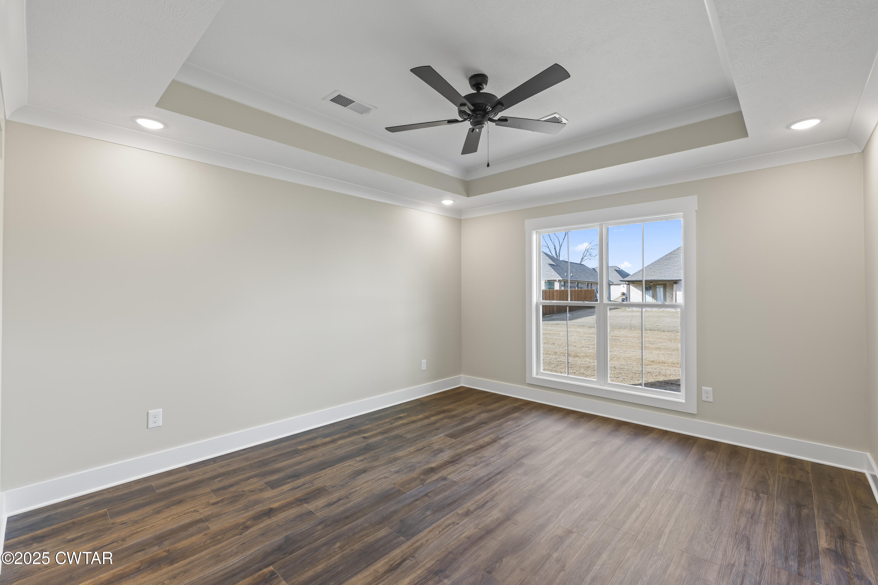 5 Easington Cove Jackson, TN 38305 - Photo 11 of 17 an empty room with wooden floor fan and windows