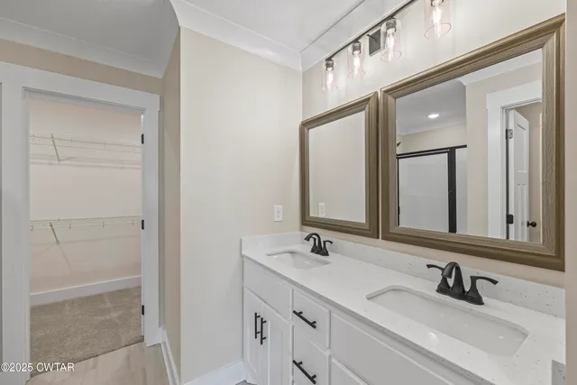 a bathroom with 2 sink and a mirror