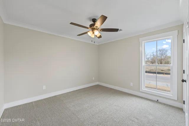 an empty room with a window and a fan